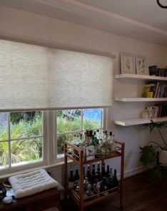 Custom sheer roller shades covering large window in stylish San Mateo living room
