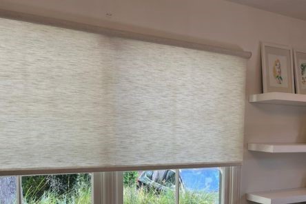 Close-up of elegant sheer window shades and contemporary furniture in sunlit San Mateo home